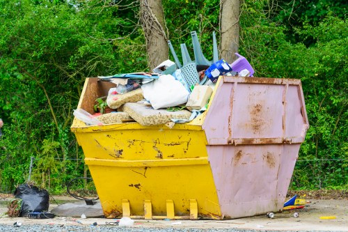 Recycling yard entrance with skips and sorting zones in Barking