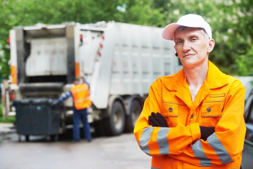 Skip hire truck outside a Barking street with clear pricing sign